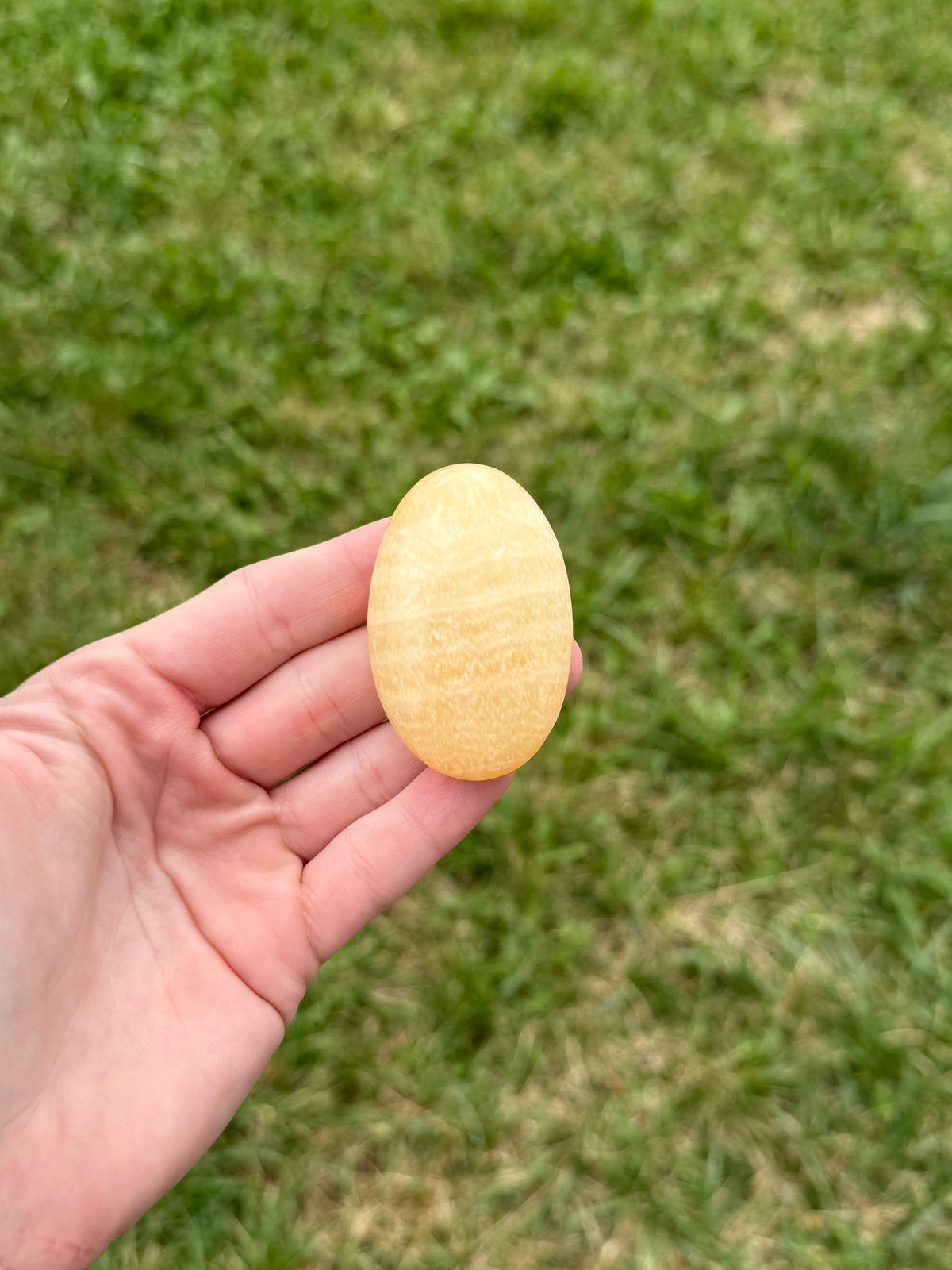 Medium orange calcite palm stones