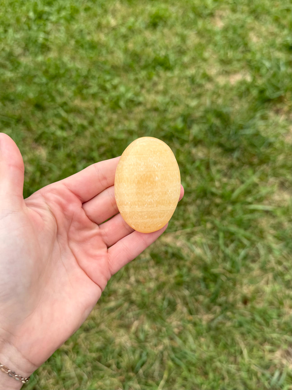 Large orange calcite palm stones