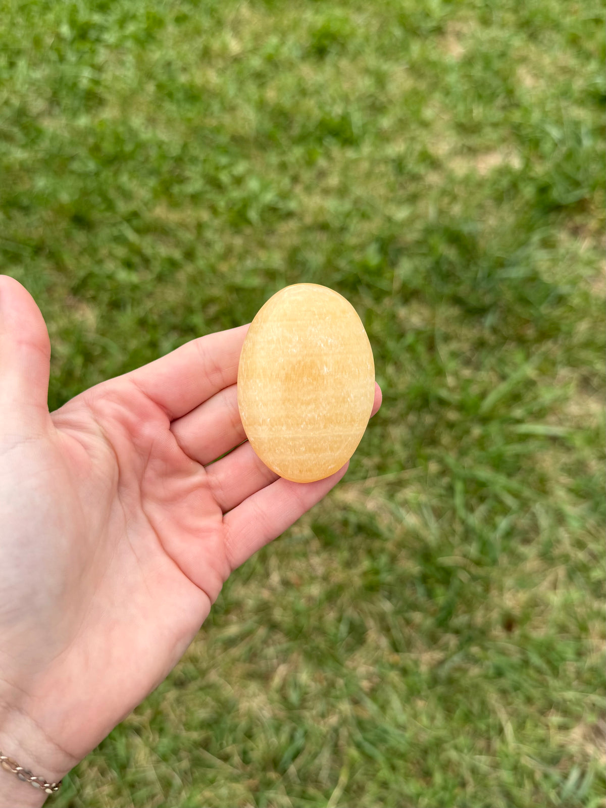 Large orange calcite palm stones