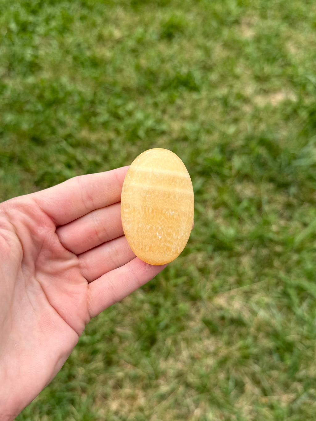 Medium orange calcite palm stones