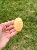 Medium orange calcite palm stones