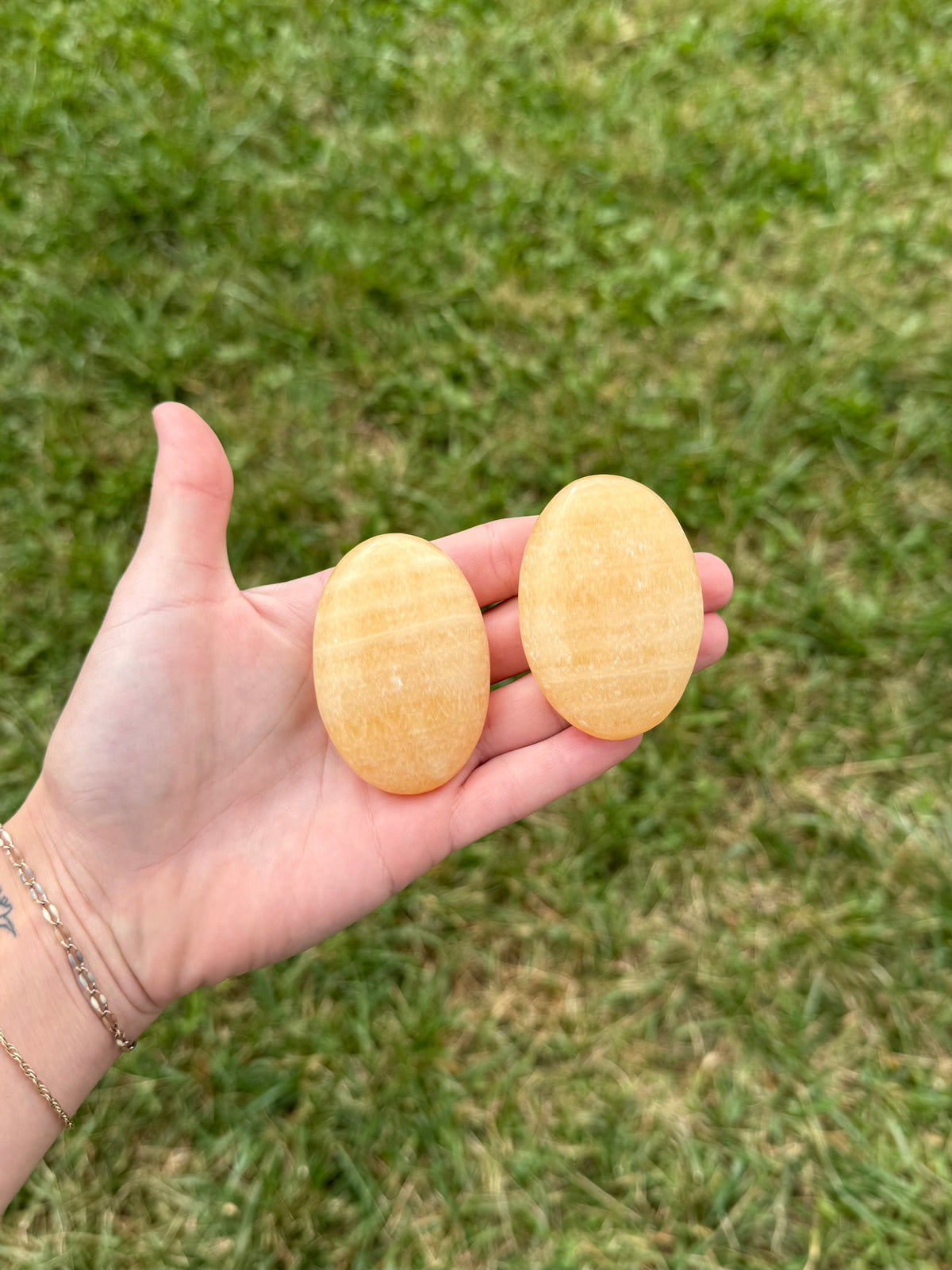 Large orange calcite palm stones