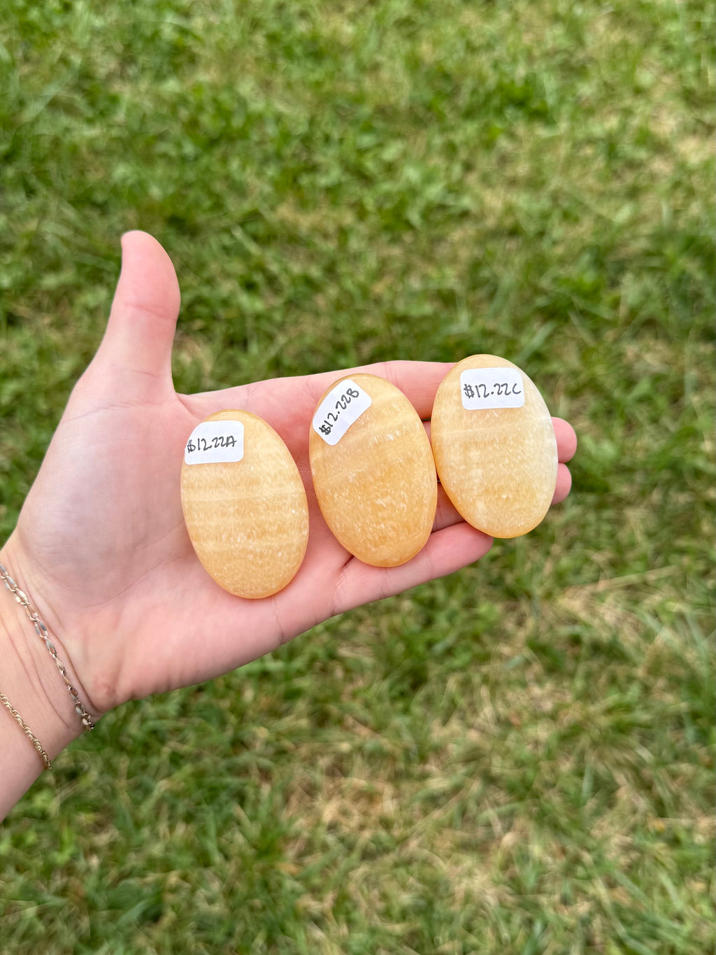 Medium orange calcite palm stones