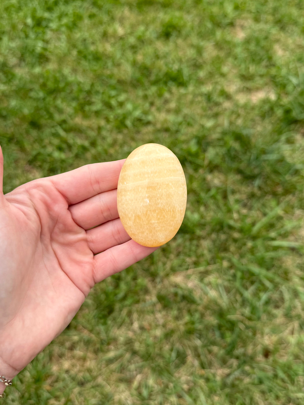 Large orange calcite palm stones