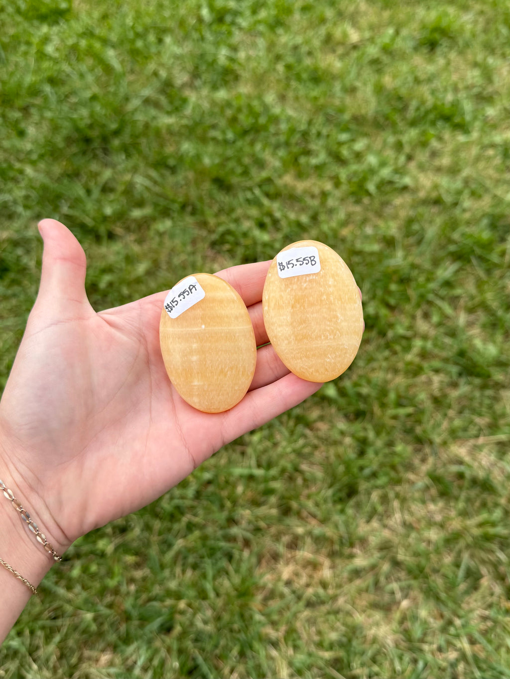 Large orange calcite palm stones