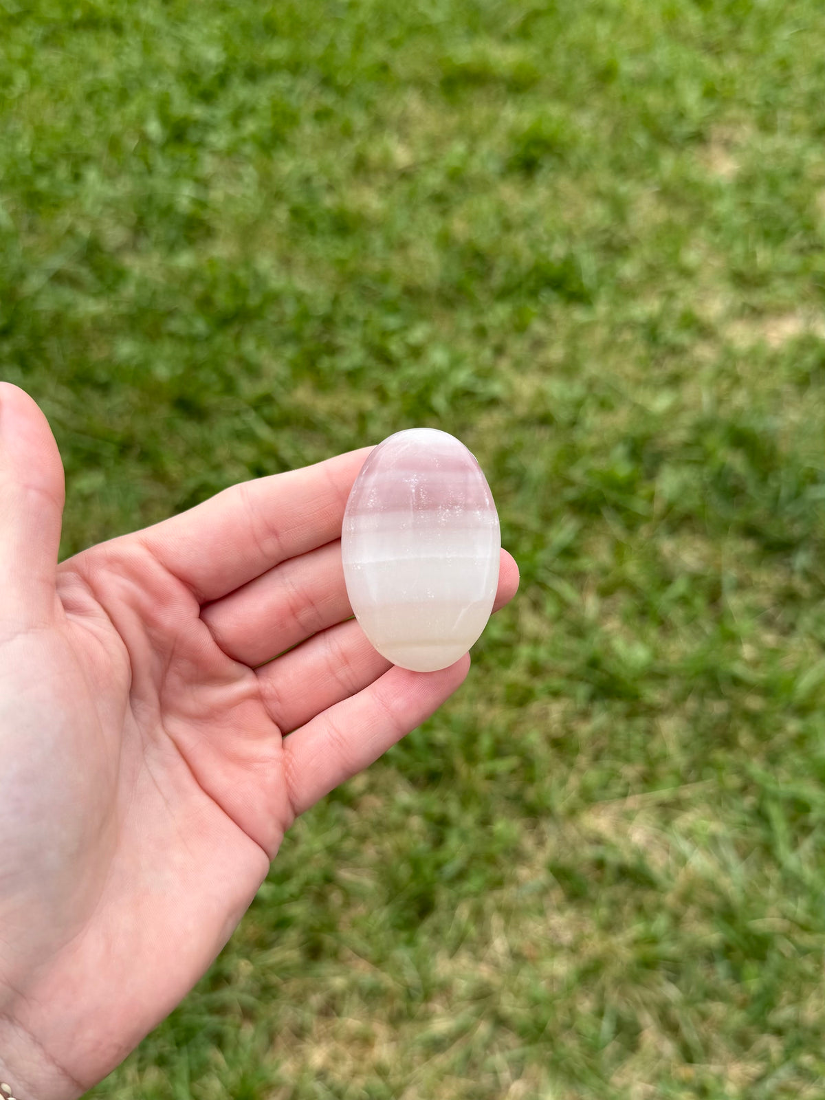 Small pink banded onyx palm stone