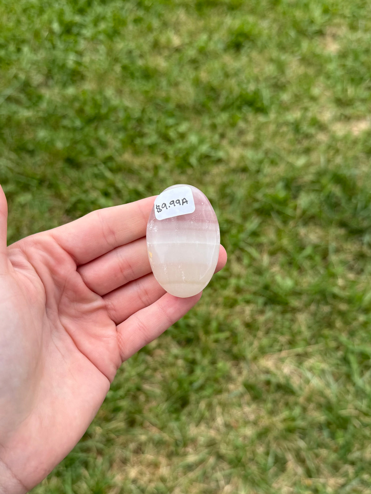 Small pink banded onyx palm stone