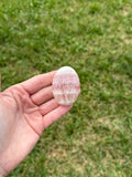 Small rose calcite palm stone