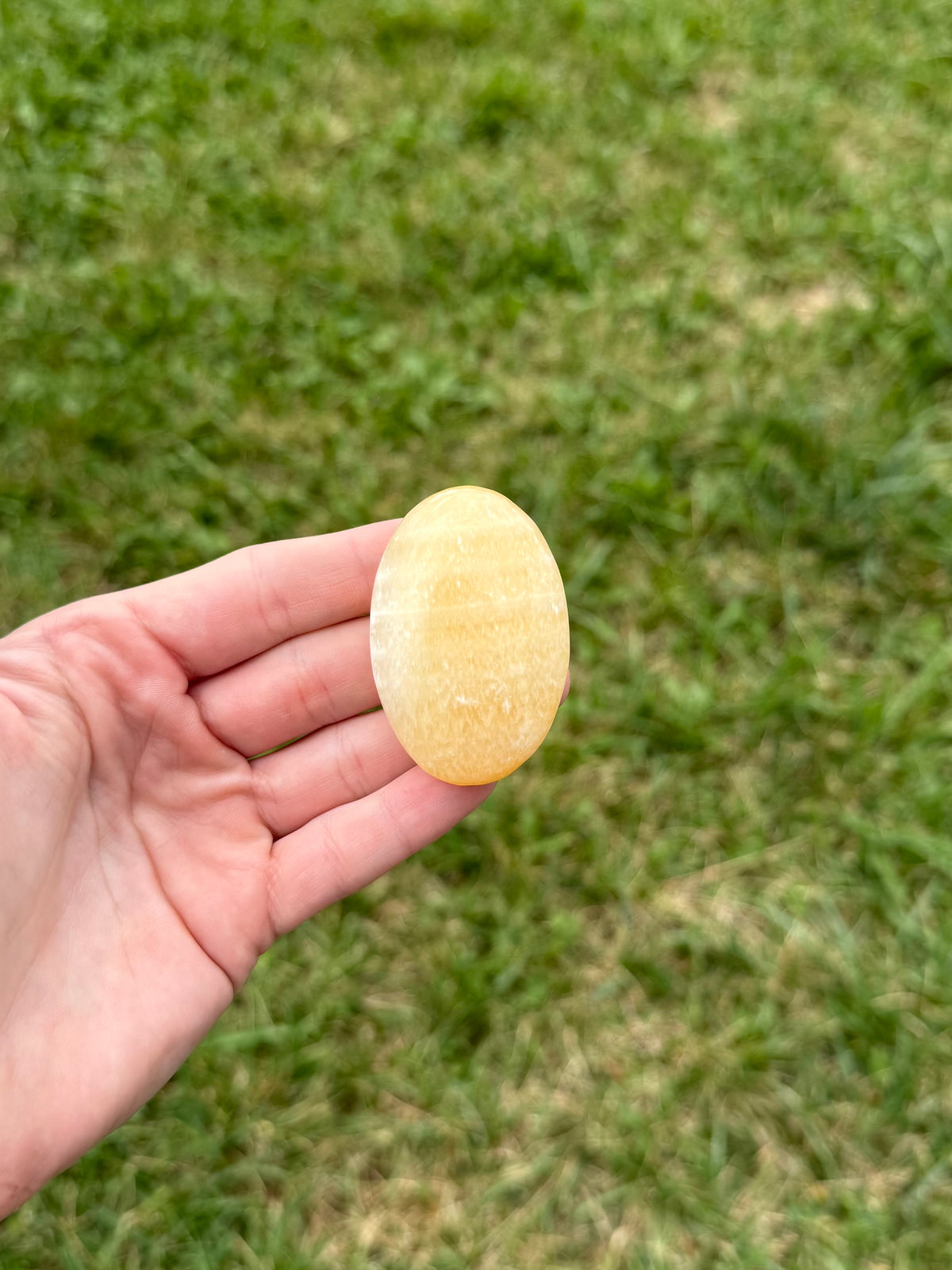Medium orange calcite palm stones