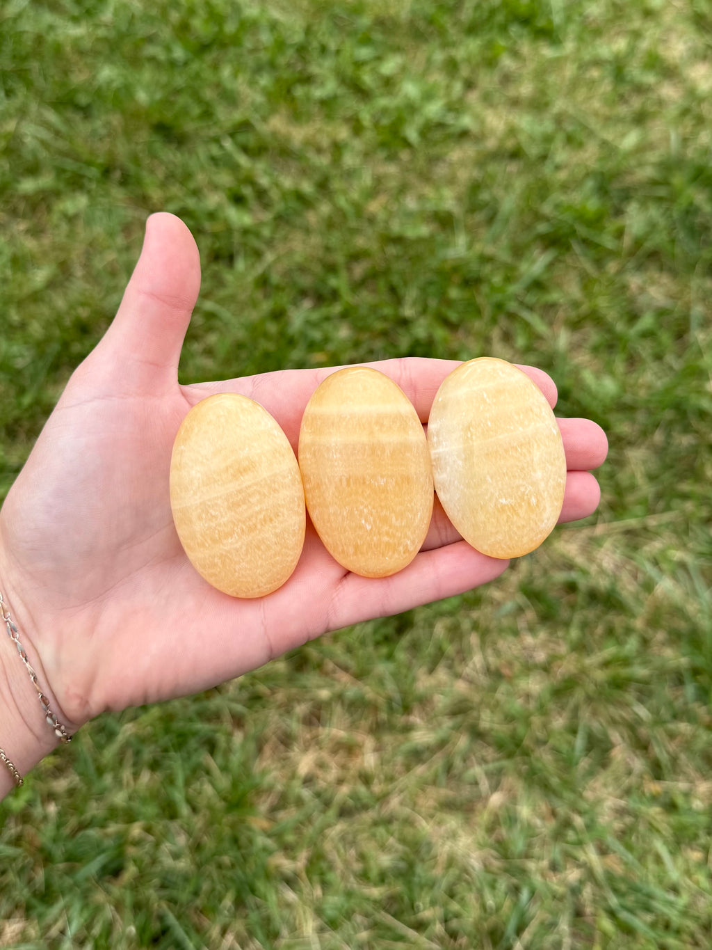 Medium orange calcite palm stones