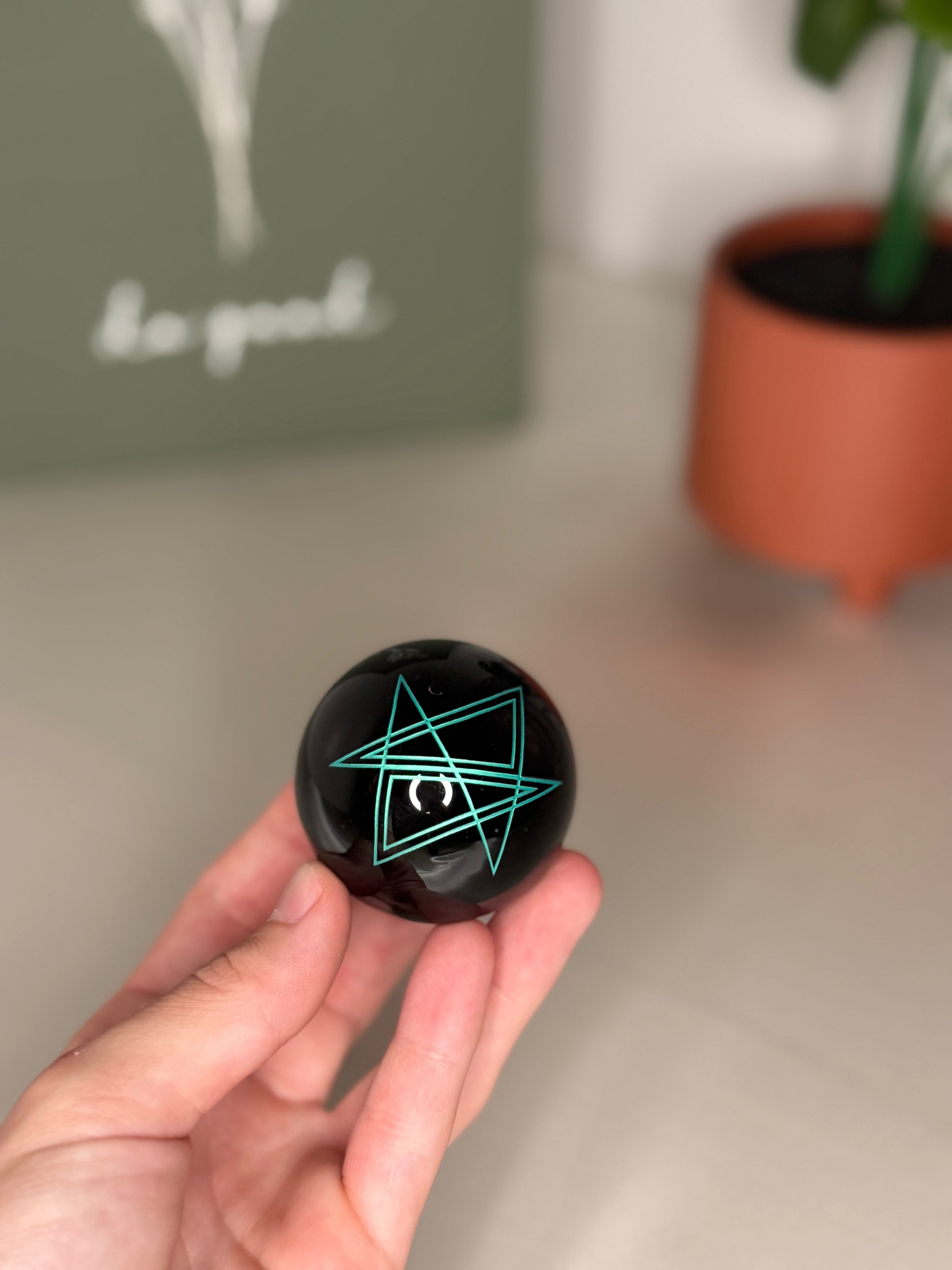 Engraved obsidian sphere
