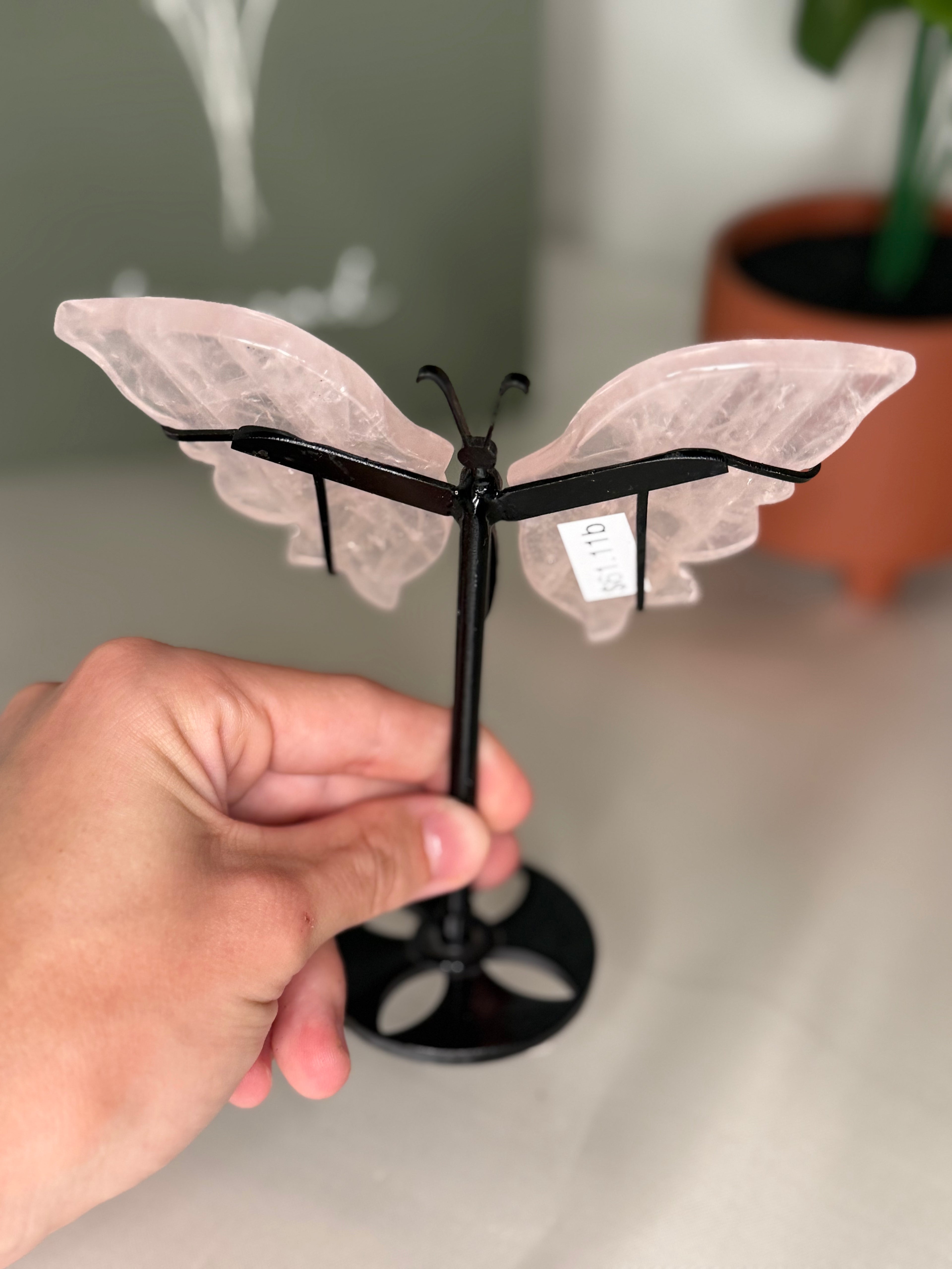 Rose quartz butterfly wings on a stand