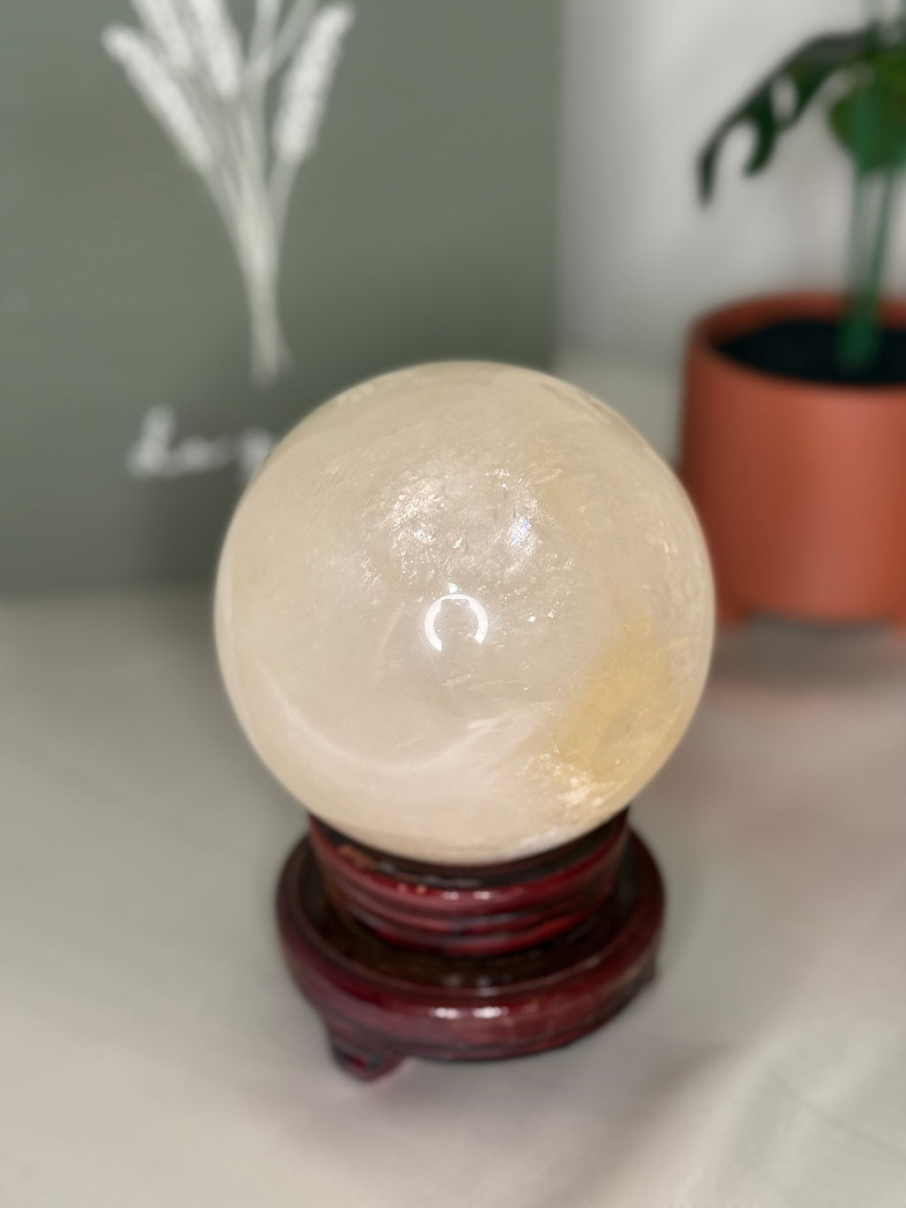 Honey calcite sphere on a spinning stand