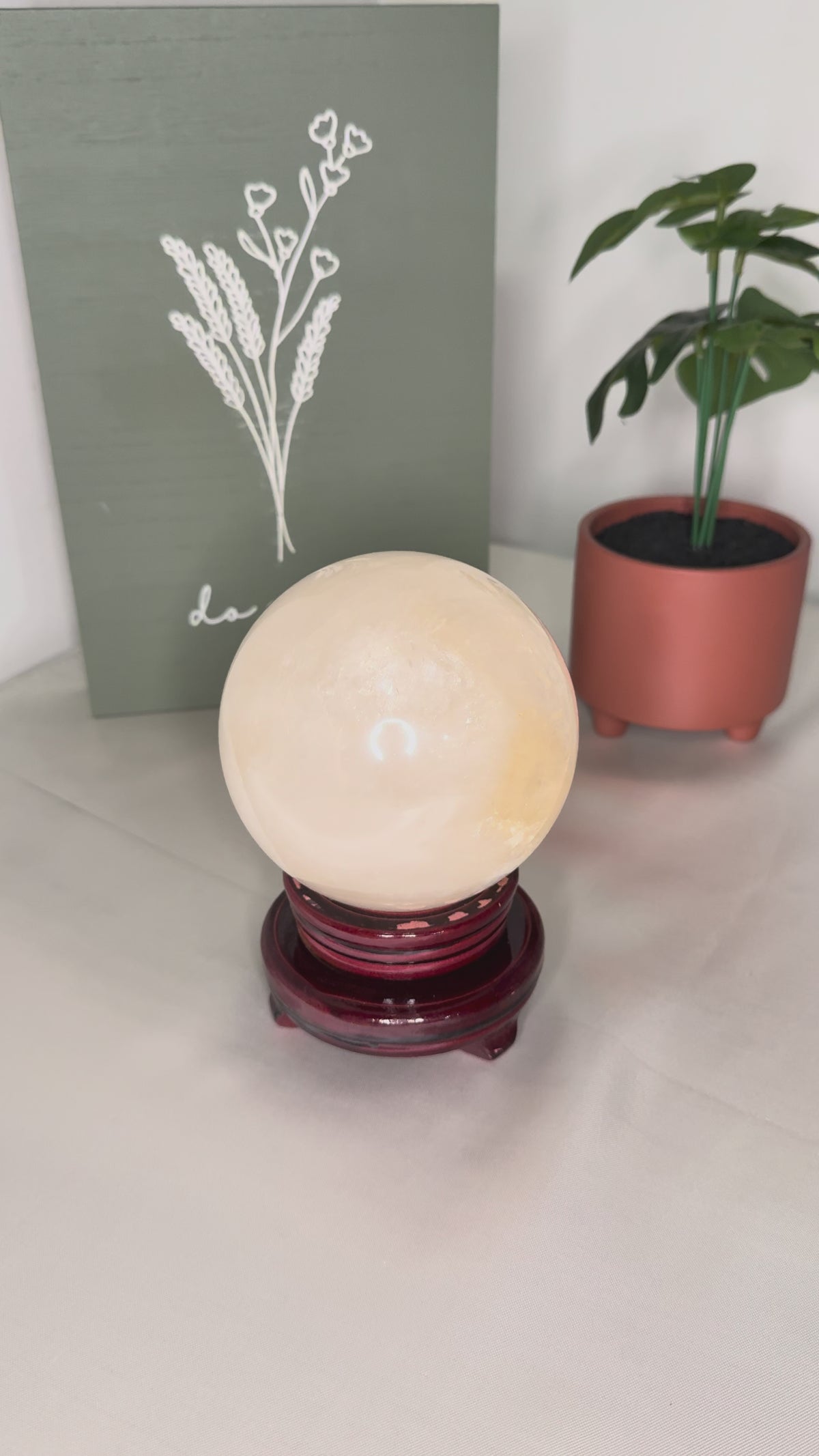 Honey calcite sphere on a spinning stand