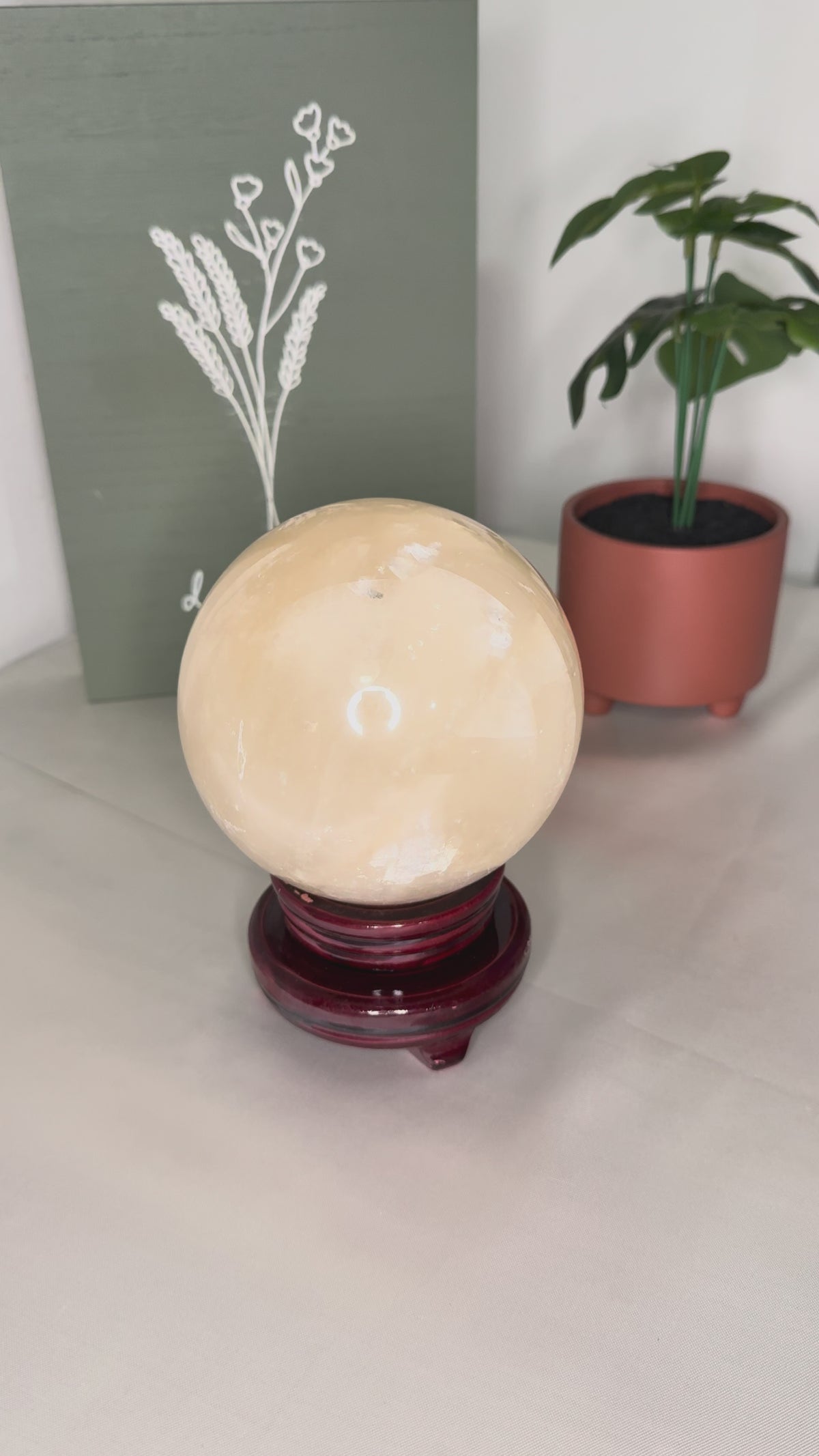 Large honey calcite sphere on spinning stand